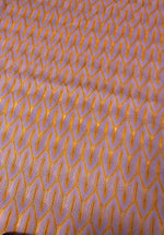 Zigzag knit jersey mesh fabric in lilac with orange zigzag pattern, lightweight and breathable textile for apparel and crafts
