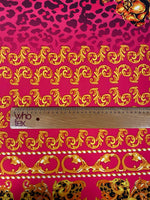 Fuchsia fabric with leopard print and gold baroque pattern, close-up with ruler for scale