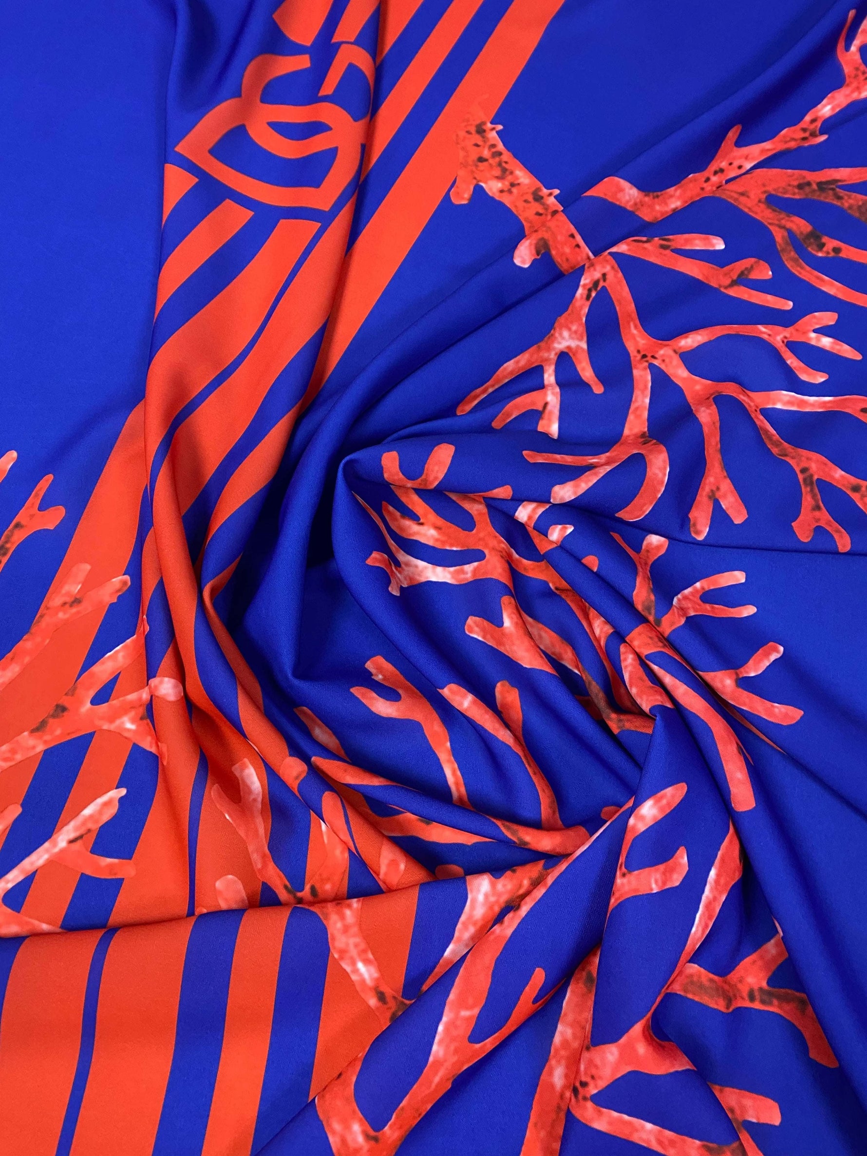 Vibrant red coral pattern on navy blue fabric panel with 150cm width for sewing and crafts
