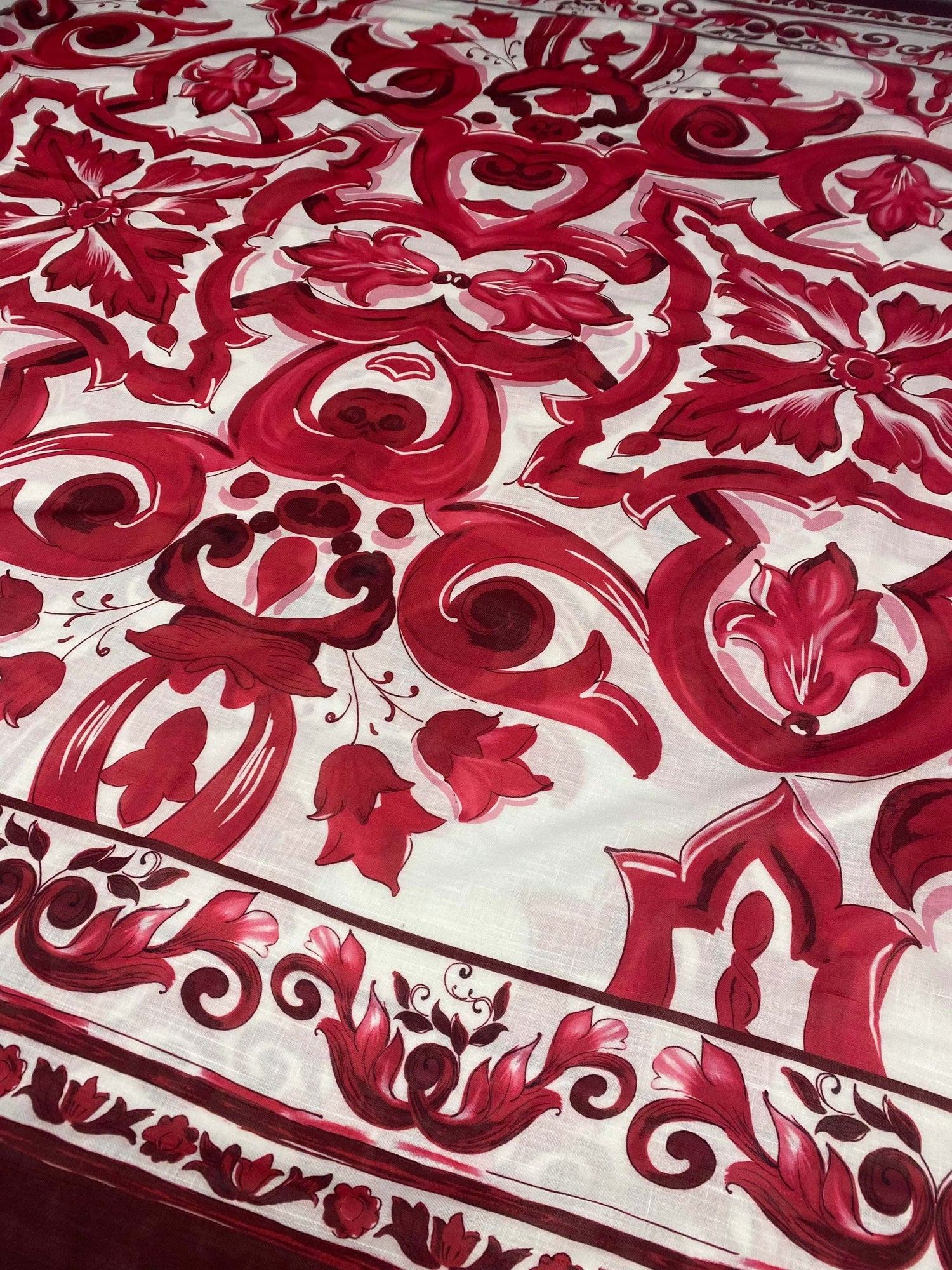 Red Baroque pattern linen fabric with intricate red floral and ornamental designs on white background for upholstery and crafts
