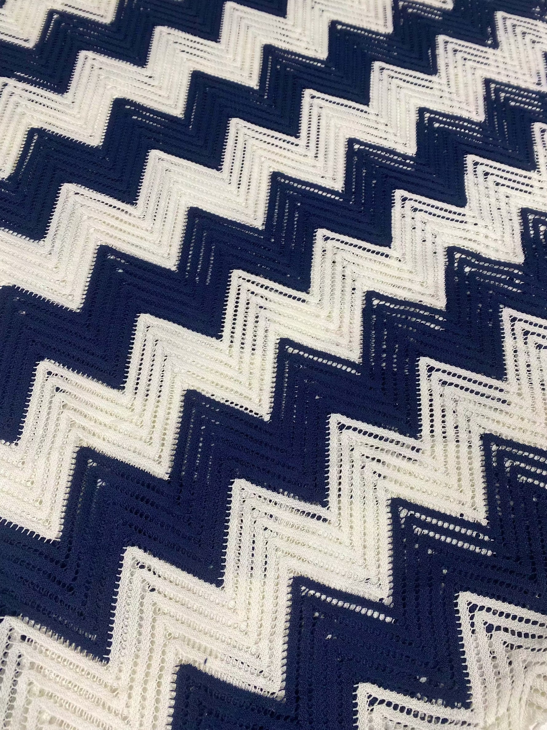 White navy zigzag mesh fabric with breathable knit texture for fashion and crafts