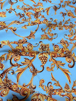 Baby blue fabric with ornate gold baroque print design suitable for sewing and home decor projects
