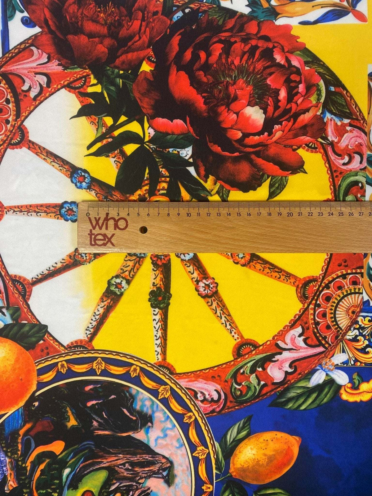 Baroque floral print fabric with colorful Mediterranean motifs and vivid reds on yellow and blue background