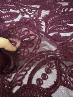 Bordeaux floral pattern lace fabric close-up showing intricate floral design and texture suitable for fashion and crafts