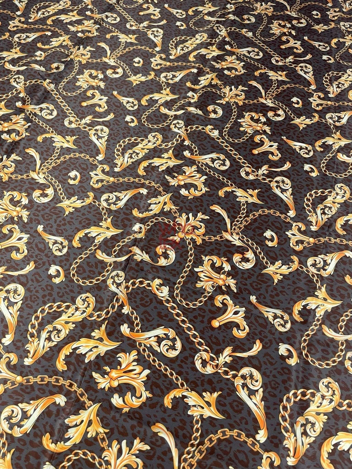 Brown leopard print fabric with gold baroque chain pattern and floral accents.