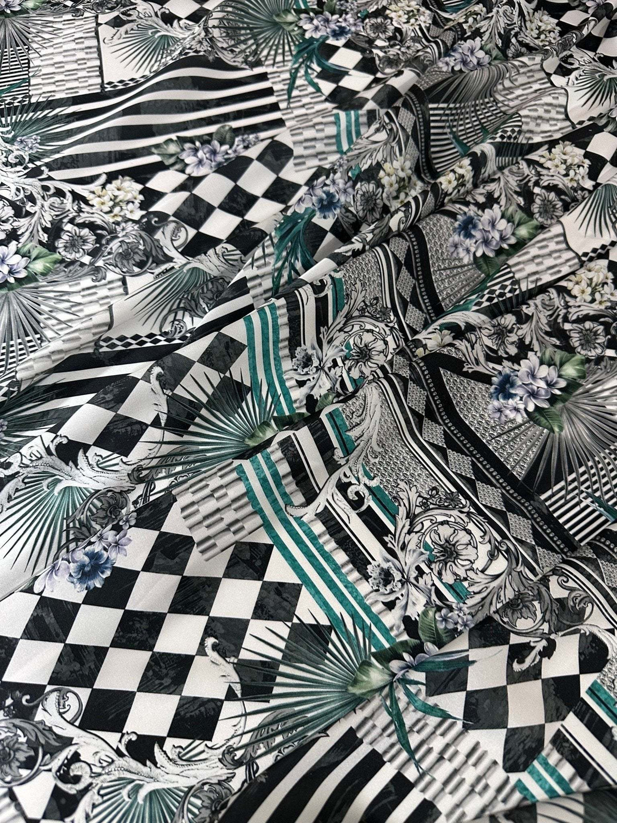 Checkerboard patchwork fabric with black and white squares and floral accents for quilting and crafting projects