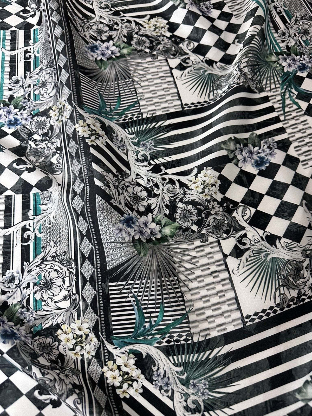Checkerboard patchwork fabric with black and white geometric patterns and floral accents, 150cm wide, ideal for quilting and crafting projects