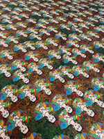 Colorful Frida Kahlo inspired floral print fabric with vibrant flowers and repeated artist portraits on a multicolored background