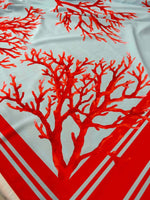 Coral pattern silky crepe fabric in red and blue with coral branch design and red border