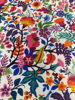 Close-up of vibrant flower design upholstery fabric with colorful floral patterns on white background
