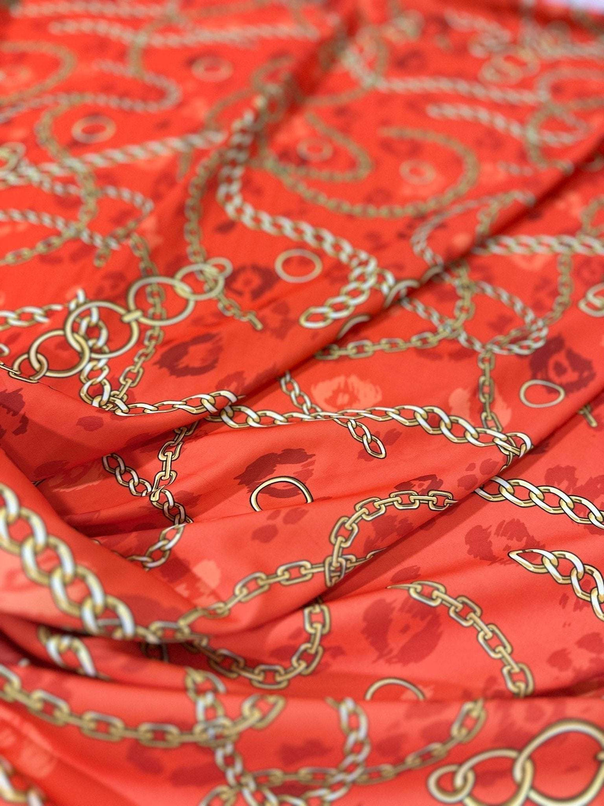Orange fabric with gold chain design pattern, 150cm wide textile for sewing projects