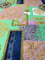 Green Baroque crepe fabric with floral and ornate patterns in green, pink, blue, and gold