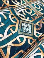 Green gold crepe silky fabric with Greek key pattern in teal and gold colors, smooth texture, and 150cm width.