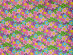 vibrant colorful floral fabric with pink, purple, blue flowers and green leaves pattern