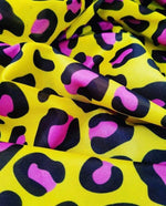 Bold yellow leopard print fabric with black and pink animal pattern, 150cm wide textile for fashion and decor projects