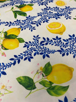 Limon Design Upholstery Fabric with vibrant yellow lemons and blue floral print on white background for home décor