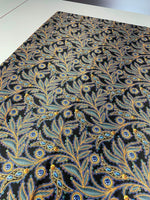 luxury peacock feather fabric with jewel accents showcasing intricate blue and gold feather designs on black background