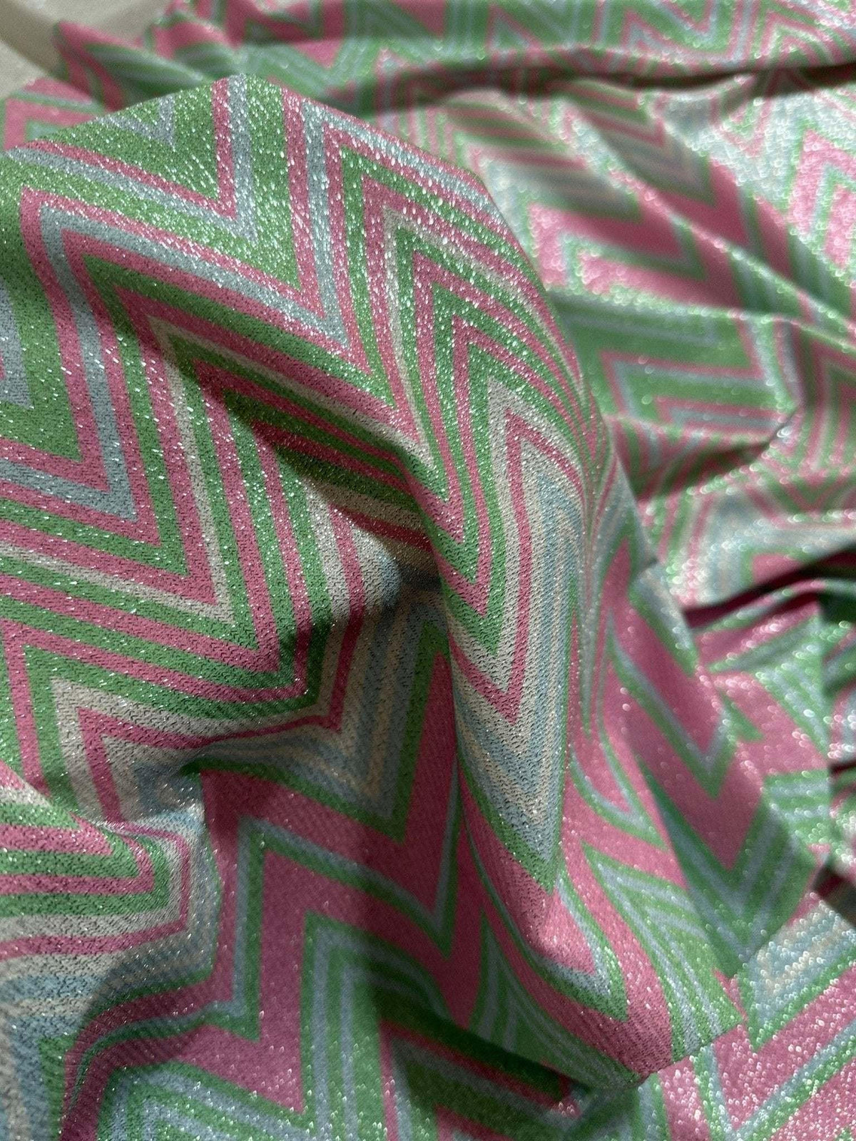 Green and pink zigzag knit lurex fabric with shimmering lightweight texture for fashion and costume projects