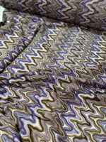 close-up of purple brown zigzag knit jersey mesh fabric with wavy pattern and texture