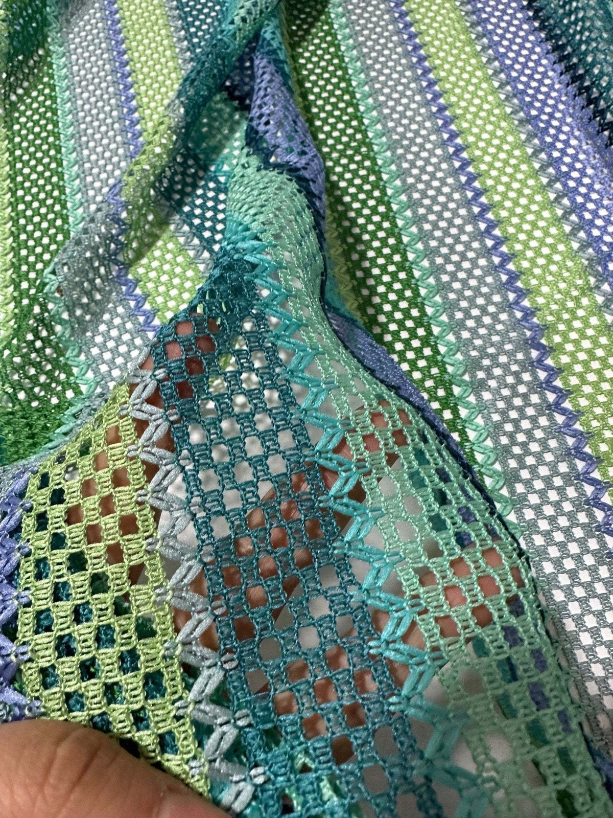 Striped knit mesh fabric with green tones and zigzag pattern for creative sewing projects