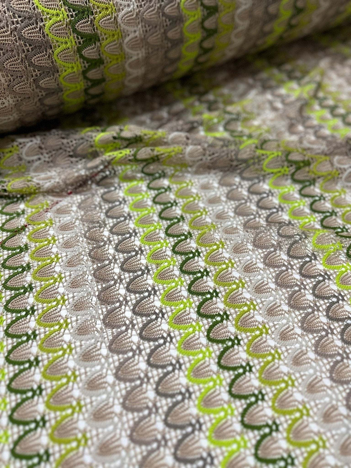 Beige green zigzag knit jersey mesh fabric with soft stretchy texture for clothing and crafts