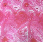 Vibrant pink tie dye fabric with swirling patterns, perfect for crafts and sewing projects, 150cm wide.