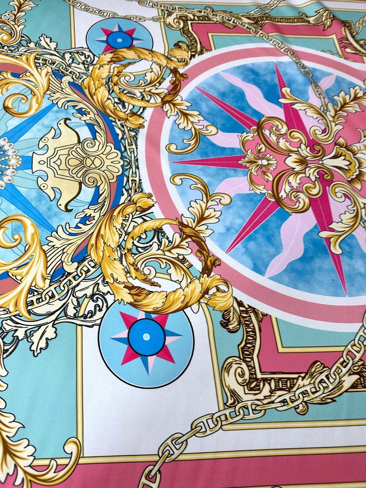 Baroque chain pattern fabric with ornate gold scrolls, compass motifs, and pastel blue and pink background