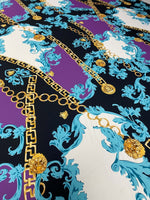 Swirl pattern crepe fabric with gold chain and turquoise floral design on purple and black background
