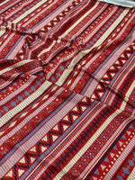 Vintage ethnic pattern shimmer lurex fabric with 4-way stretch in red and purple tones, ideal for sportswear, activewear, and costumes.