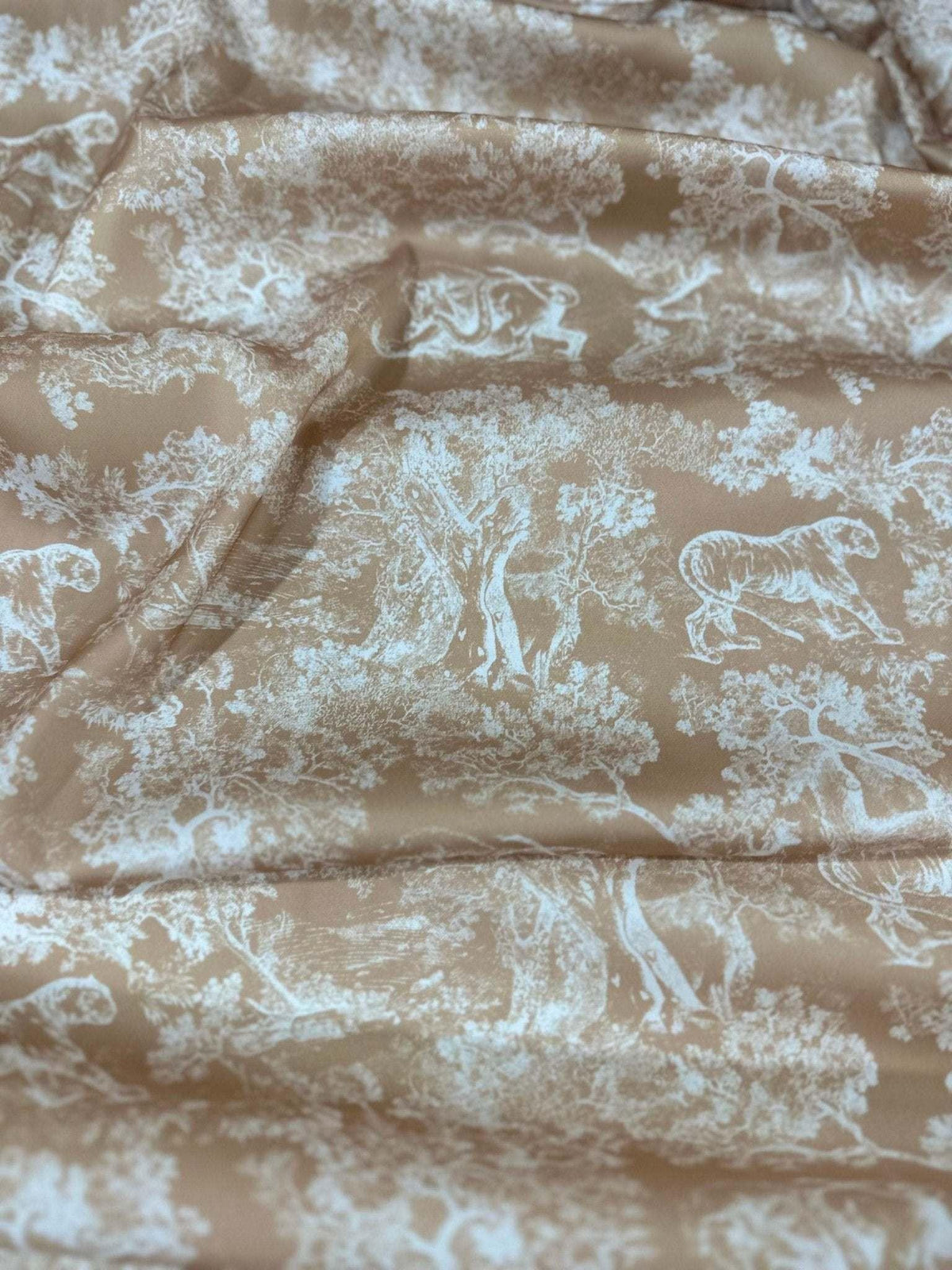 Beige fabric with white wild forest animal and tree pattern, soft texture textile for sewing projects