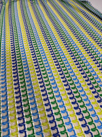 Luxury zigzag knit jersey fabric with blue, yellow, and green chevron pattern in a soft, stretchy texture